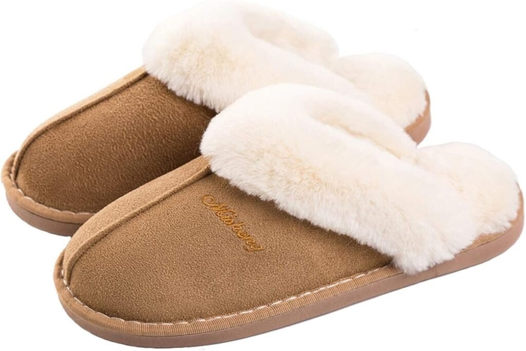 Brown suede indoor slippers with fluffy white faux fur lining, featuring detailed stitching and embroidered text on the upper, ideal for cozy home use.