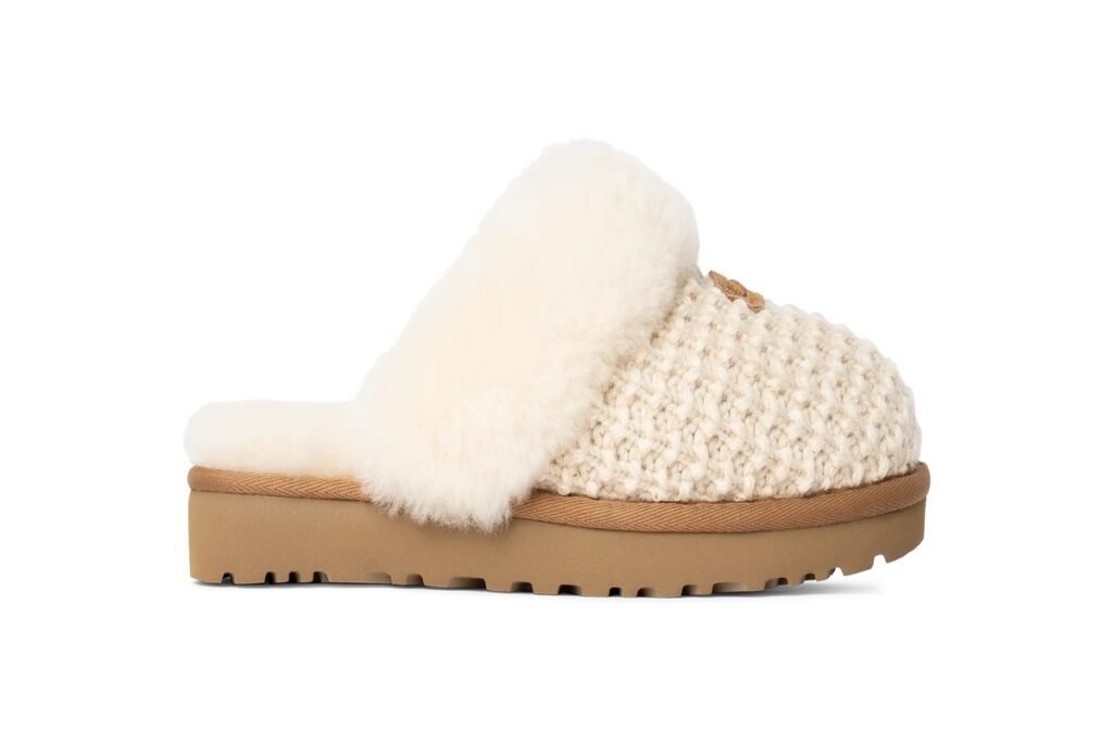Side profile of a cream-colored knit slipper with a soft plush cuff and durable sole, blending comfort and fashion.
